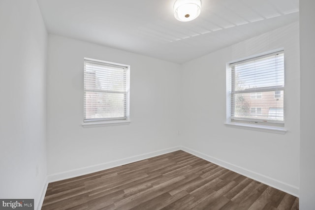 2900 Pomeroy Rd SE Unit 203, Washington, DC 20020 - empty room featuring plenty of natural light, dark wood-type flooring, and baseboards
