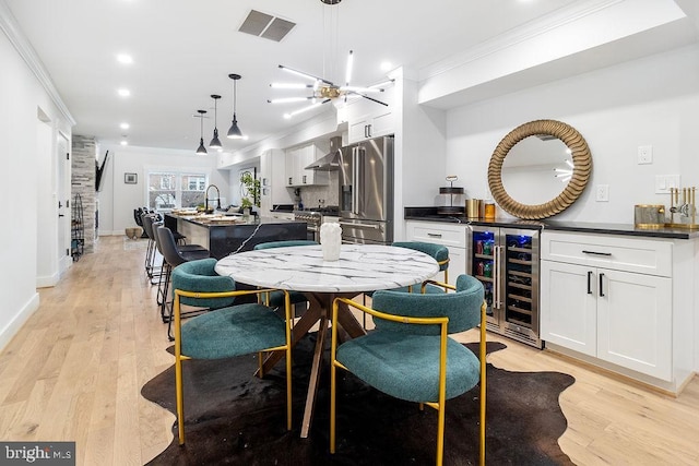 1242 Meigs Pl NE Unit C, Washington, DC 20002 - dining space with wine cooler, ornamental molding, light wood-style floors, recessed lighting, and bar area