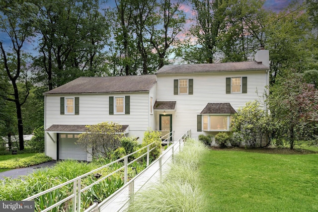 337 Greene Rd, Berwyn, PA 19312 - view of front of property with driveway, a chimney, an attached garage, a lawn, and a shingled roof