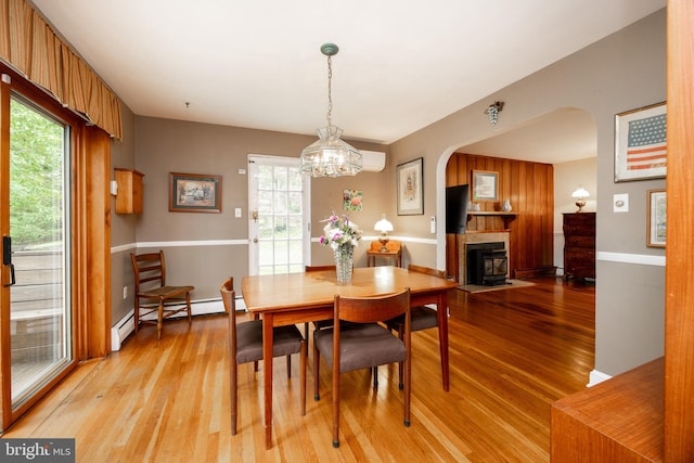337 Greene Rd, Berwyn, PA 19312 - dining room featuring arched walkways, light wood-style flooring, a baseboard radiator, and a chandelier