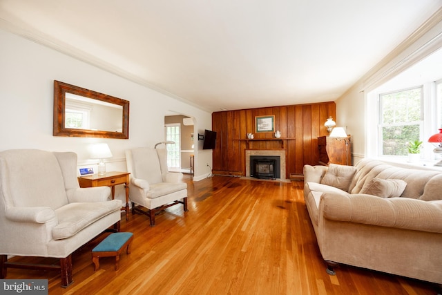 337 Greene Rd, Berwyn, PA 19312 - living room with arched walkways, light wood-type flooring, ornamental molding, a fireplace with flush hearth, and a baseboard heating unit