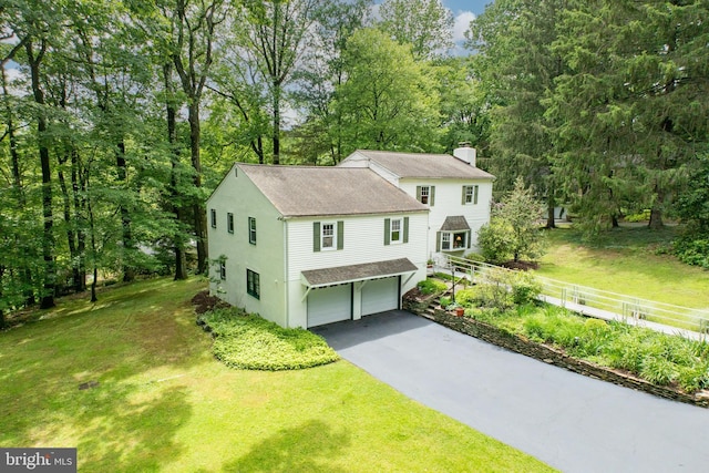 337 Greene Rd, Berwyn, PA 19312 - view of front facade featuring a chimney, a garage, asphalt driveway, and a shingled roof