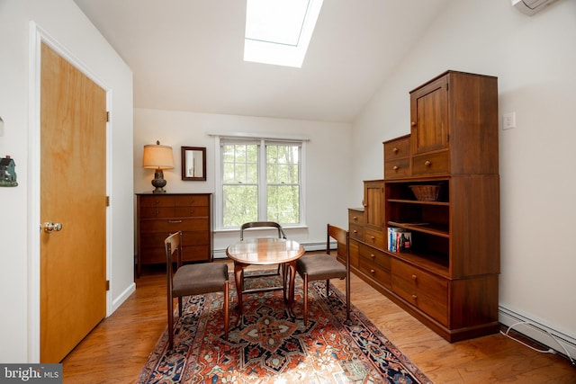 337 Greene Rd, Berwyn, PA 19312 - dining room with a baseboard heating unit, a skylight, light wood-type flooring, and vaulted ceiling