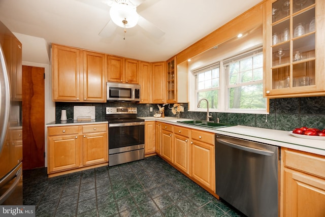 337 Greene Rd, Berwyn, PA 19312 - kitchen with stainless steel appliances, a sink, dark flooring, decorative backsplash, and light countertops