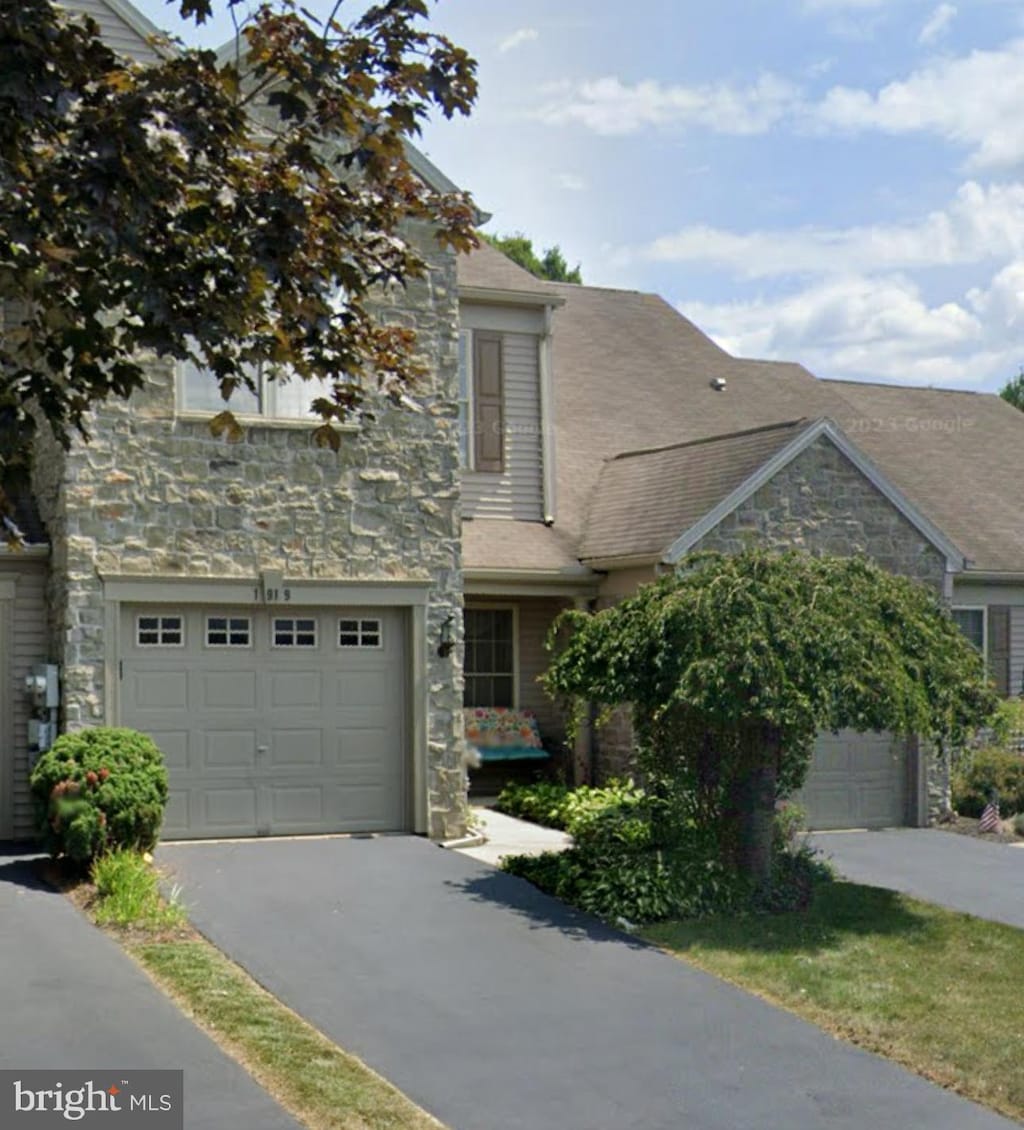 1919 Limestone Dr, Hummelstown, PA 17036 - view of front of property featuring stone siding, asphalt driveway, and a garage