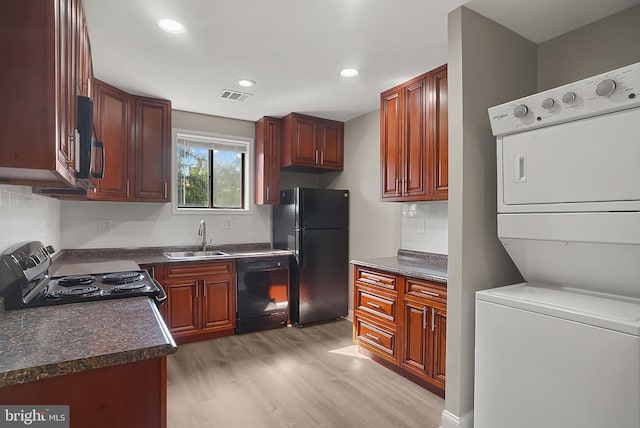3922 Rolling Rd Unit A8, Pikesville, MD 21208 - kitchen with black appliances, stacked washer / dryer, dark countertops, light wood-style flooring, and recessed lighting