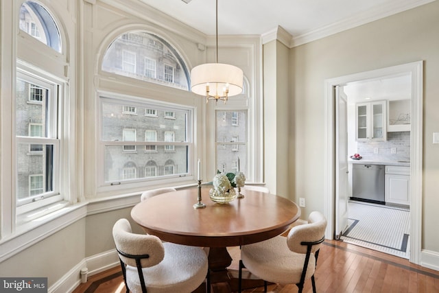 1830 S Rittenhouse Square 12C And 12D, Philadelphia, PA 19103 - dining space featuring hardwood / wood-style flooring, plenty of natural light, a chandelier, and crown molding