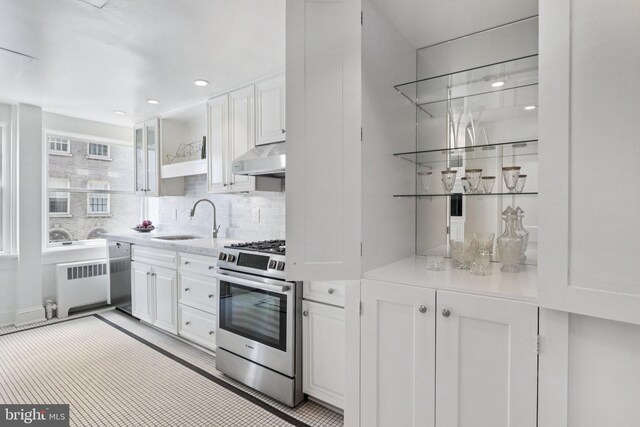1830 S Rittenhouse Square 12C And 12D, Philadelphia, PA 19103 - kitchen featuring appliances with stainless steel finishes, a sink, radiator, under cabinet range hood, and white cabinetry