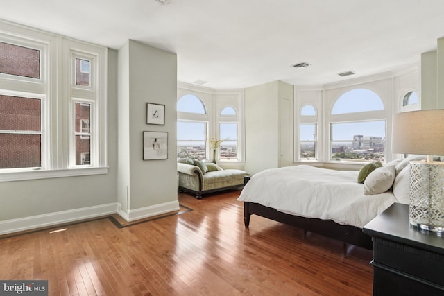 1830 S Rittenhouse Square 12C And 12D, Philadelphia, PA 19103 - bedroom featuring multiple windows, baseboards, and wood-type flooring