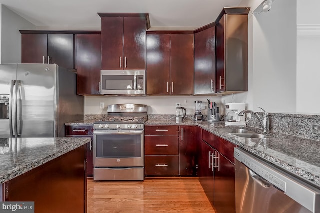 2620 Egret Way, Frederick, MD 21701 - kitchen with stainless steel appliances, a sink, dark stone countertops, and light wood-type flooring