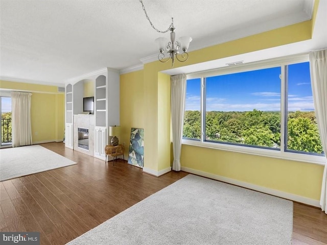2956 Hathaway Rd Unit 1205, Richmond, VA 23225 - unfurnished living room featuring a fireplace, a chandelier, baseboards, wood finished floors, and a textured ceiling