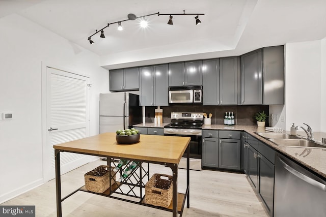 400 Massachusetts Ave NW Unit 223, Washington, DC 20001 - kitchen featuring stainless steel appliances, a sink, gray cabinetry, light wood finished floors, and backsplash