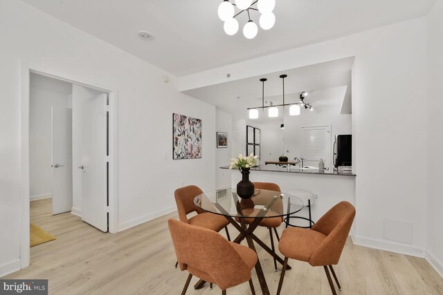 400 Massachusetts Ave NW Unit 223, Washington, DC 20001 - dining space with light wood-type flooring, baseboards, and a chandelier