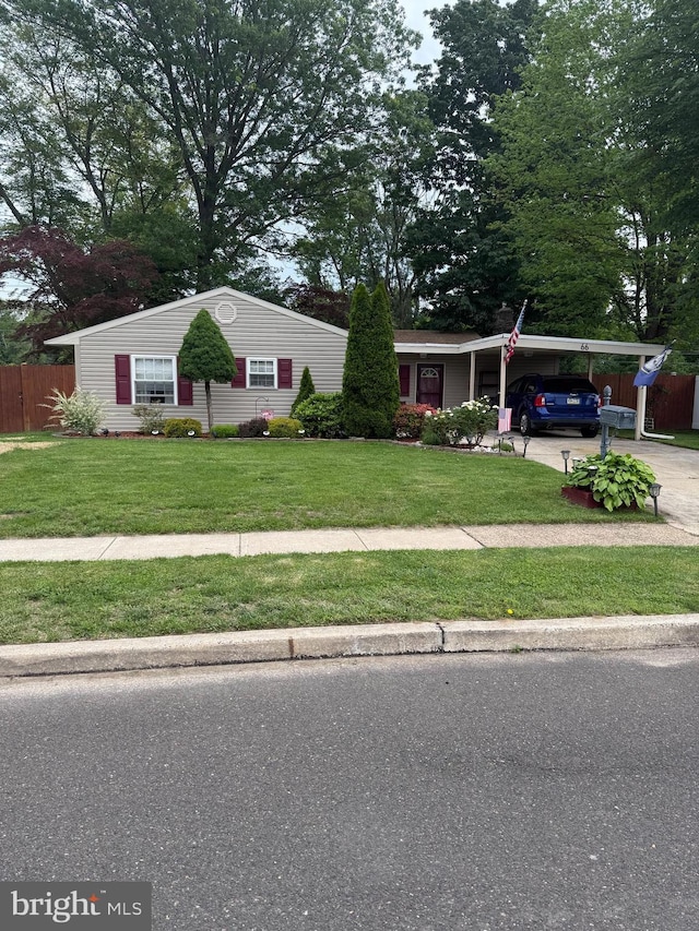 66 Yellowood Dr, Levittown, PA 19057 - ranch-style house featuring concrete driveway and a carport