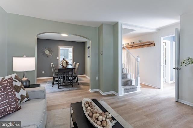 5634 8th Rd N, Arlington, VA 22205 - living room featuring arched walkways, light wood-type flooring, and stairway