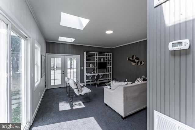 5634 8th Rd N, Arlington, VA 22205 - living area with healthy amount of natural light, a skylight, crown molding, carpet flooring, and french doors