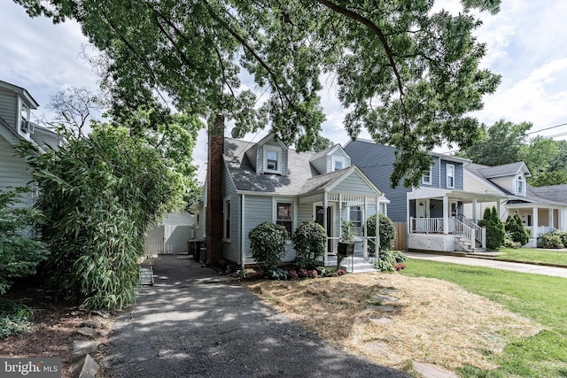 5634 8th Rd N, Arlington, VA 22205 - view of front of property with driveway, covered porch, and a chimney