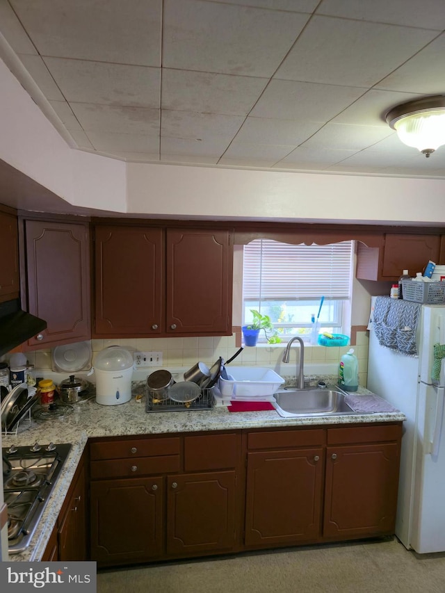 9618 Hoff St, Philadelphia, PA 19115 - kitchen with freestanding refrigerator, stainless steel gas stovetop, decorative backsplash, a sink, and range hood