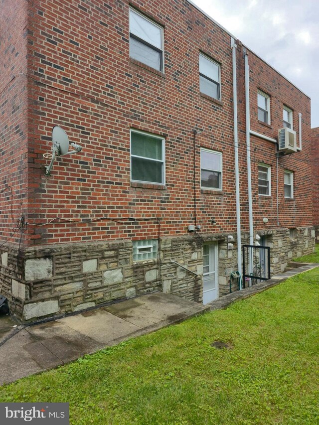 9618 Hoff St, Philadelphia, PA 19115 - view of side of property featuring brick siding, cooling unit, and a yard