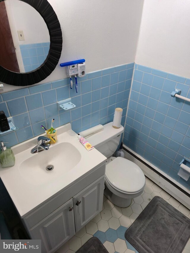 9618 Hoff St, Philadelphia, PA 19115 - bathroom featuring vanity, tile walls, toilet, wainscoting, and tile patterned floors