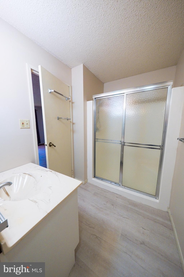 702 Downing Ct, Westampton, NJ 08060 - full bathroom featuring vanity, wood finished floors, a shower with door, and a textured ceiling