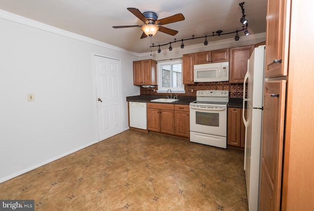 702 Downing Ct, Westampton, NJ 08060 - kitchen with white appliances, a sink, dark countertops, rail lighting, and tasteful backsplash