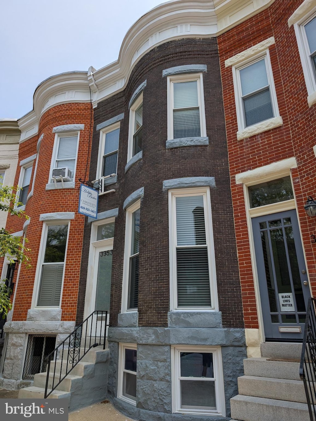 3353 Beech Ave, Baltimore, MD 21211 - townhome / multi-family property with entry steps, brick siding, cooling unit, and stone siding