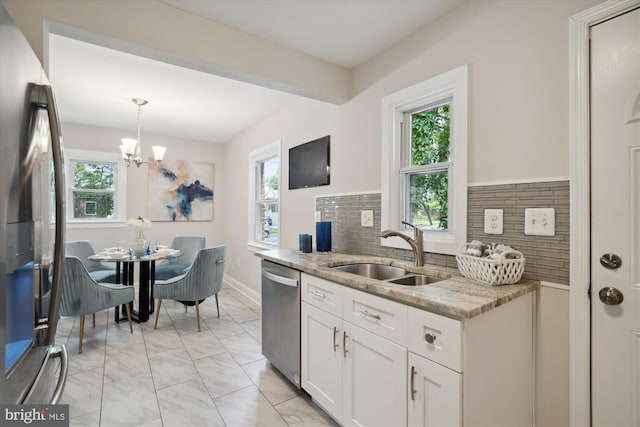 5609 35th Ave, Hyattsville, MD 20782 - kitchen with stainless steel appliances, a sink, healthy amount of natural light, and light marble finish floors