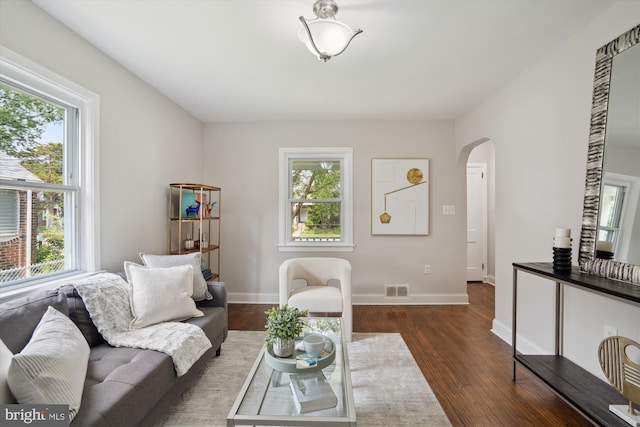 5609 35th Ave, Hyattsville, MD 20782 - living area with arched walkways, plenty of natural light, dark wood-style flooring, and baseboards