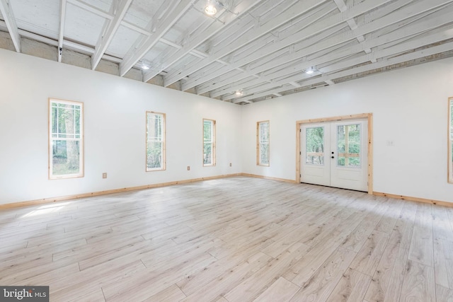 9532 Lyons Mill Rd, Owings Mills, MD 21117 - unfurnished room featuring french doors, light wood-style floors, healthy amount of natural light, and baseboards