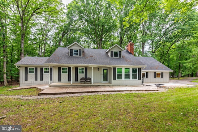 9532 Lyons Mill Rd, Owings Mills, MD 21117 - view of front of property with a chimney, a front lawn, a porch, and roof with shingles