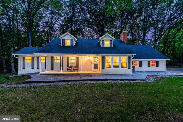 9532 Lyons Mill Rd, Owings Mills, MD 21117 - back of house with a chimney, board and batten siding, a lawn, a porch, and a shingled roof