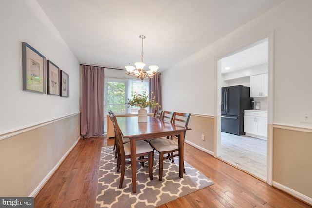 43501 Plantation Ter, Ashburn, VA 20147 - dining space with a chandelier, light wood finished floors, and baseboards