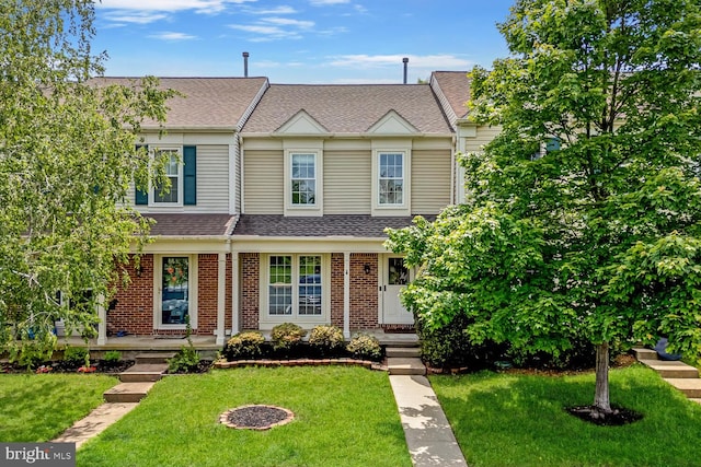43501 Plantation Ter, Ashburn, VA 20147 - townhome / multi-family property featuring a front lawn, a shingled roof, and brick siding