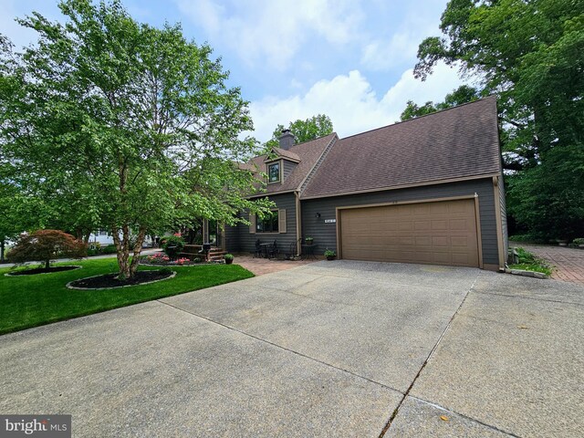 35 Read St, Seaford, DE 19973 - view of front facade with driveway, an attached garage, a front yard, roof with shingles, and a chimney