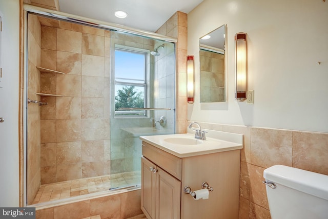4000 Cathedral Ave NW Unit 517B, Washington, DC 20016 - bathroom featuring tile walls, vanity, a stall shower, and recessed lighting