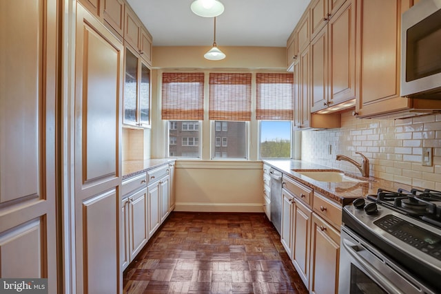 4000 Cathedral Ave NW Unit 517B, Washington, DC 20016 - kitchen with stainless steel appliances, tasteful backsplash, pendant lighting, and light stone countertops