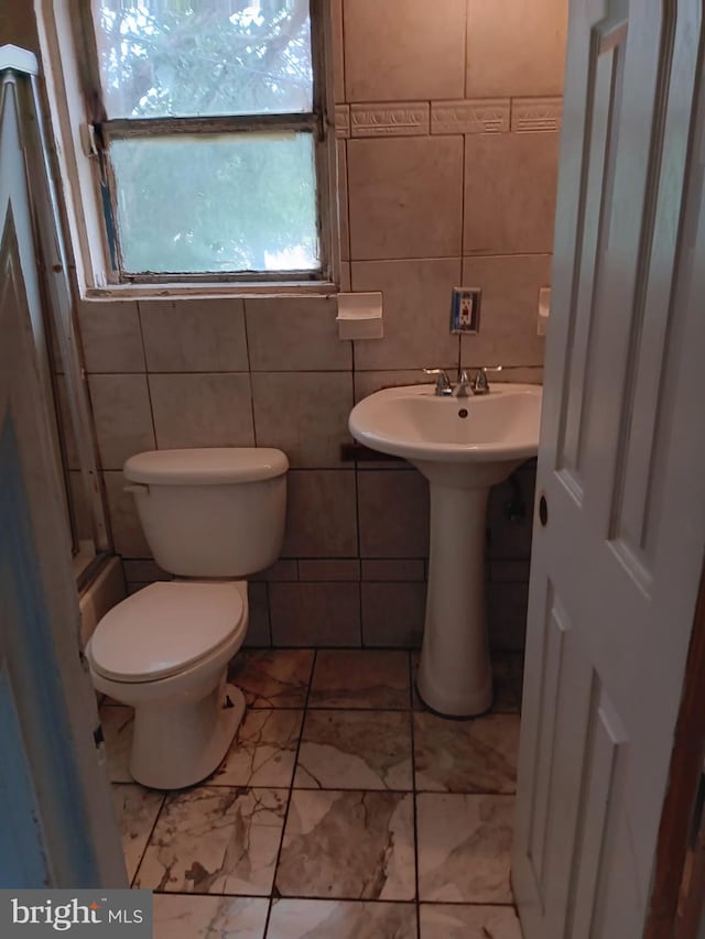 1911 Ray Leonard Rd, Landover, MD 20785 - bathroom featuring tile walls, toilet, and marble finish flooring