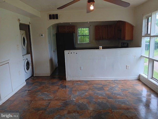 1911 Ray Leonard Rd, Landover, MD 20785 - kitchen featuring stacked washer / dryer, arched walkways, a ceiling fan, and healthy amount of natural light