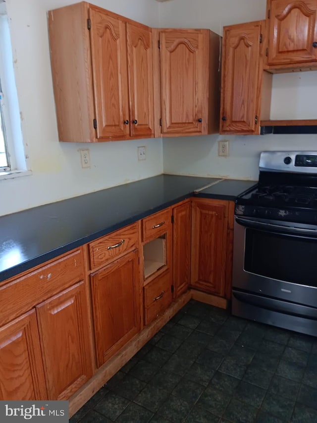 1911 Ray Leonard Rd, Landover, MD 20785 - kitchen featuring stainless steel gas range oven, dark countertops, and brown cabinets