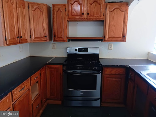 1911 Ray Leonard Rd, Landover, MD 20785 - kitchen featuring stainless steel range with gas cooktop, dark countertops, and brown cabinetry