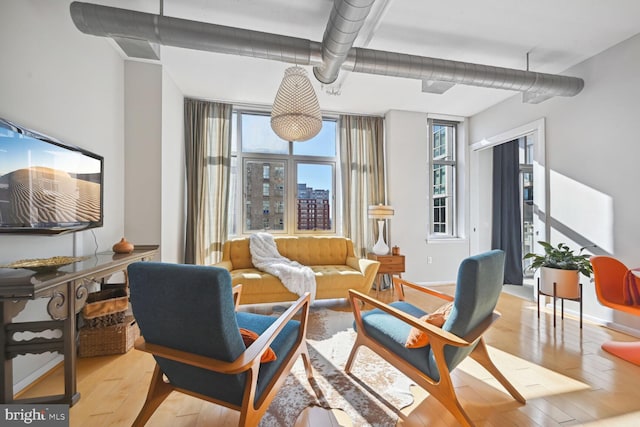 811 4th St NW Unit 720, Washington, DC 20001 - living area featuring hardwood / wood-style flooring, healthy amount of natural light, and baseboards
