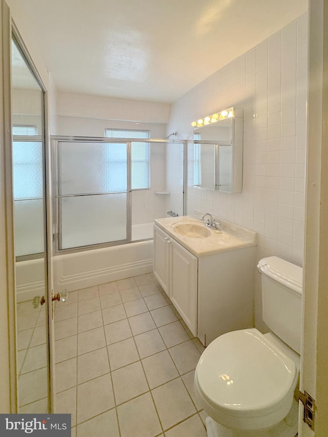 4000 Cathedral Ave NW Unit 518B, Washington, DC 20016 - full bath featuring tile patterned flooring, tile walls, combined bath / shower with glass door, and vanity