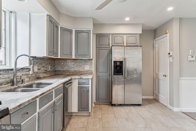 254 Bryn Mawr Ave, Lansdowne, PA 19050 - kitchen with gray cabinets, stainless steel appliances, a sink, tasteful backsplash, and ceiling fan