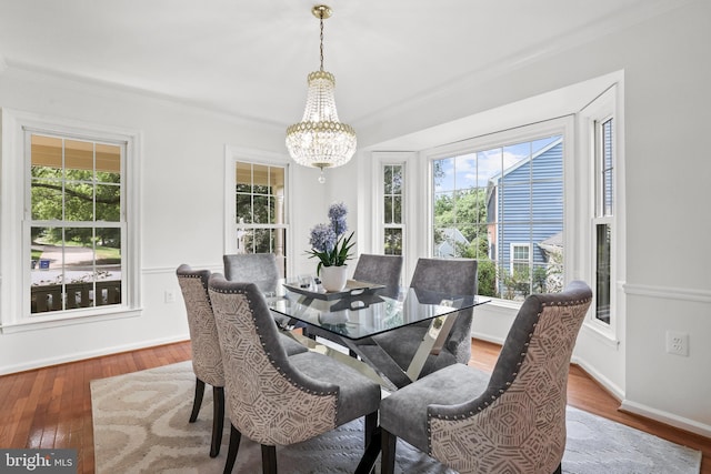13412 Glen Taylor Ln, Herndon, VA 20171 - dining space featuring a chandelier, wood finished floors, and crown molding