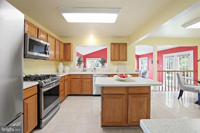 13412 Glen Taylor Ln, Herndon, VA 20171 - kitchen featuring appliances with stainless steel finishes, light countertops, a center island, and brown cabinetry