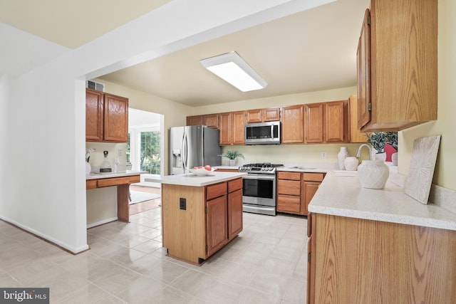 13412 Glen Taylor Ln, Herndon, VA 20171 - kitchen with stainless steel appliances, a kitchen island, and brown cabinetry