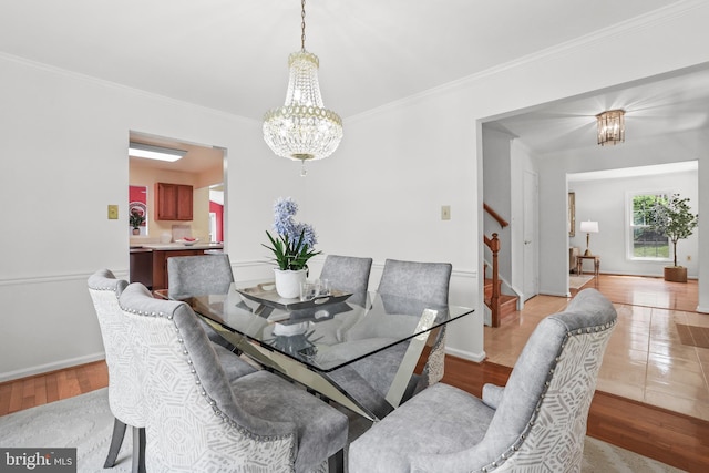 13412 Glen Taylor Ln, Herndon, VA 20171 - dining room with a chandelier, stairs, ornamental molding, and light wood-style floors