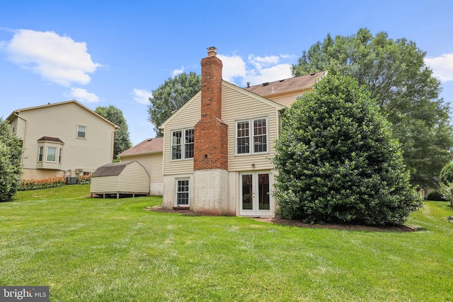 13412 Glen Taylor Ln, Herndon, VA 20171 - rear view of house featuring french doors, a yard, a chimney, and brick siding