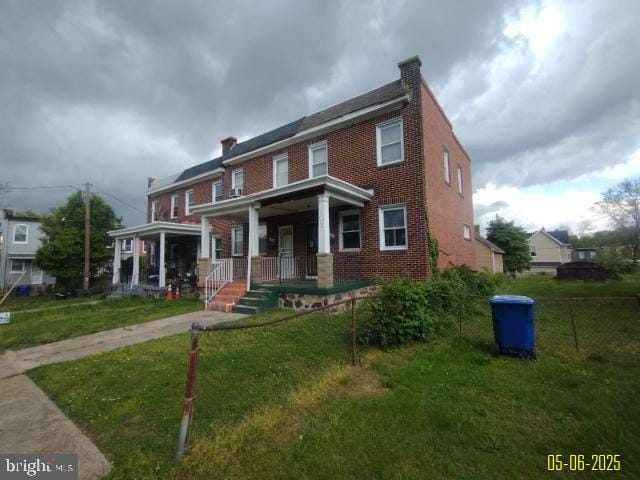608 Chestnut Hill Ave, Baltimore, MD 21218 - townhome / multi-family property with a porch, a chimney, and brick siding
